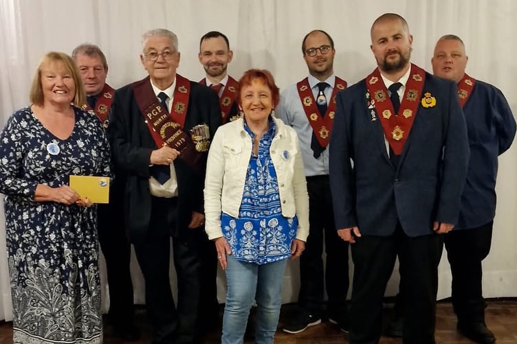 Milford Haven RAOB Harbour Lodge members present £400 to representatives from Forget-Me-Knot.