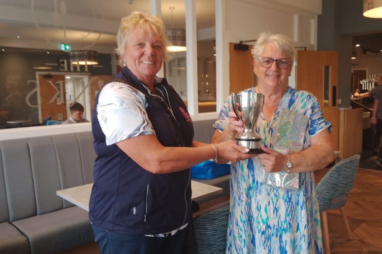 Mel Smith being presented with trophy by current Ladies Captain Penny Cope