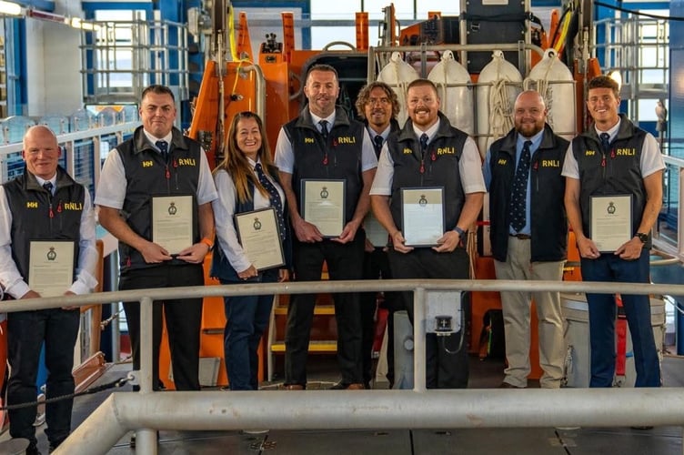 Tenby RNLI lifeboat crew members have been recognised for saving lives in two daring sea rescues.