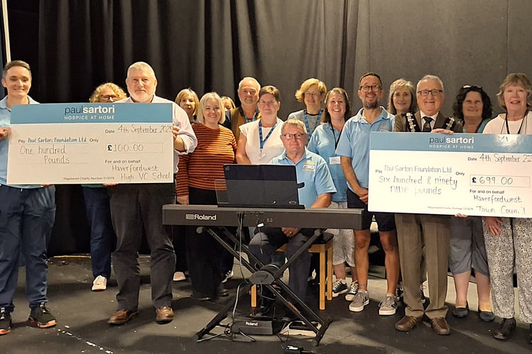 Councillor Roy Thomas, Mayor of Haverfordwest (centre); Reg White Community Liaison Lead at Haverfordwest High VC School (left); Amanda Elmes and Judith Williams Choir Coordinators along with Mark Heron Musical Director of Paul Sartori Community Choir and Peter Griffiths Accompanist (at the new digital piano). Also pictured are several of the Paul Sartori Community Choir members.
