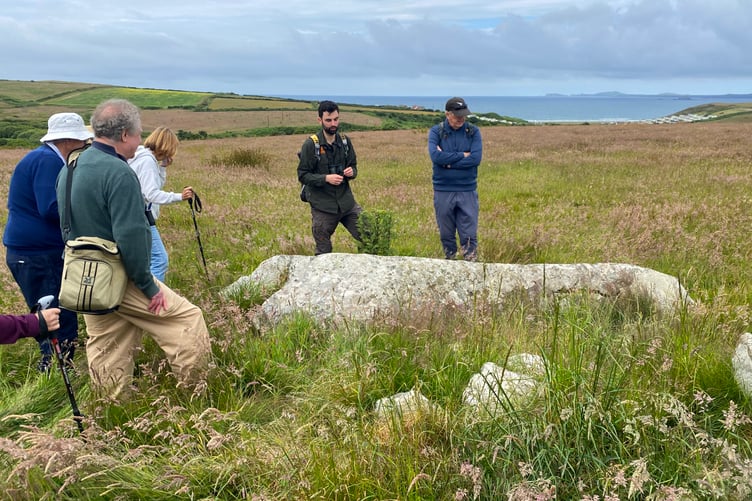 Members of the Pembrokeshire National Trust Association on a walk at Southwood near Newgale, guided by James Roden, Pembrokeshire National Trust Countryside Manager. Glacial erratic