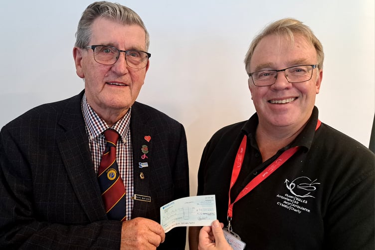 Air Ambulance volunteer and Probus member Rhys Watkins presents Mike May, Wales Air Ambulance, with a donation from the club