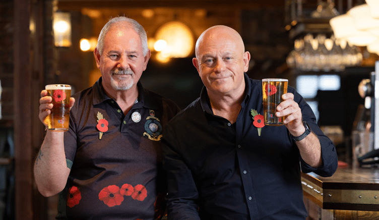 Marine veteran Colin Waite raises a glass with Ross Kemp.