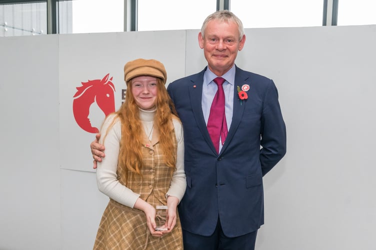 Samantha seen receiving the award from BHS President, actor Martin Clunes.