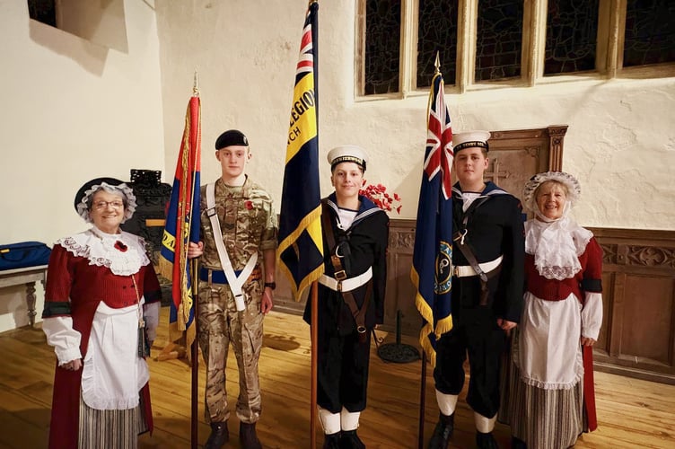 Flag bearers representing Tenby Sea Cadets and Tenby Army Cadets, along with Welsh Ladies, supporting the choir and representing the cultural traditions of Wales.