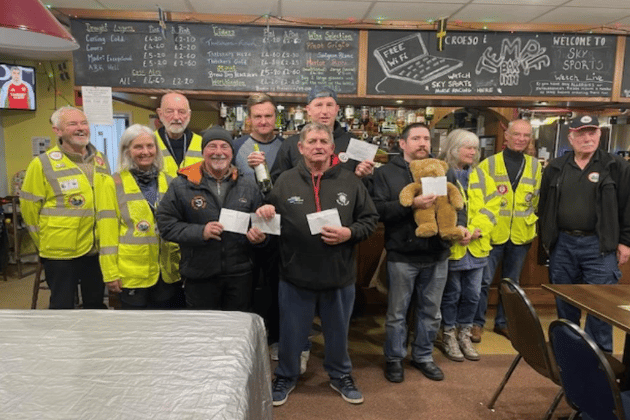 In the centre, Haydn Cole with Paull (L) and Mickey (R), Ben and Rob behind, flanked by Blood Bikes Wales Members and Peter Kraus extreme right (Pic by Barbara Thorne)