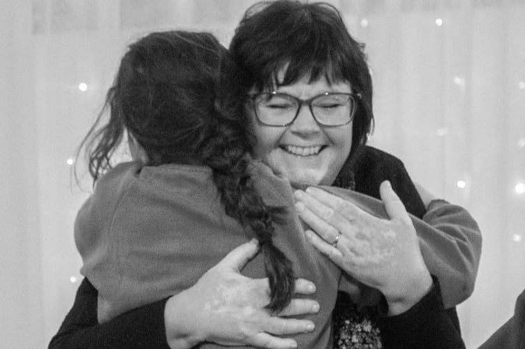 Sandy Bear Staff, Lee Morrisey having a hug from young child