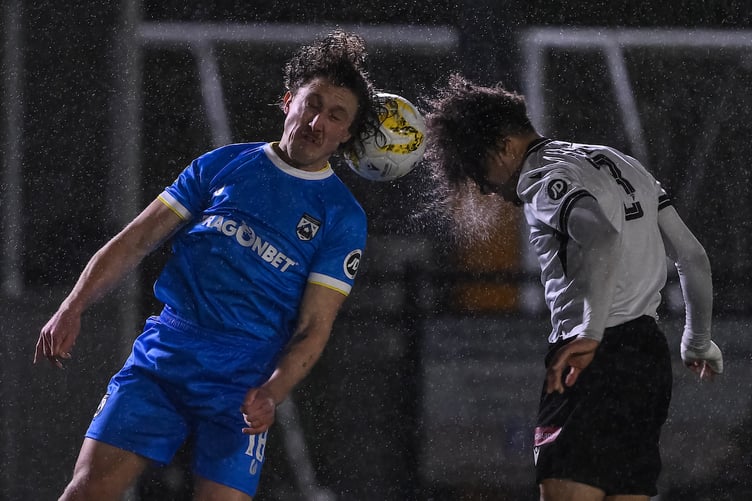 BALA, WALES - 05 December 2025: Greg Walters of Haverfordwest County and Lewis Hall of Bala Town battles for the ball during the JD Cymru Premier between Bala Town and Haverfordwest County at the Maes Tegid in Bala. (Pic by Craig Thomas/FAW)