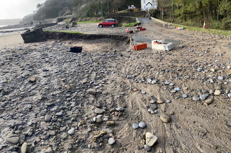 A road strewn with stones and debris at Wiseman’s Bridge after a rough tide resulted in further damage to the sea bank