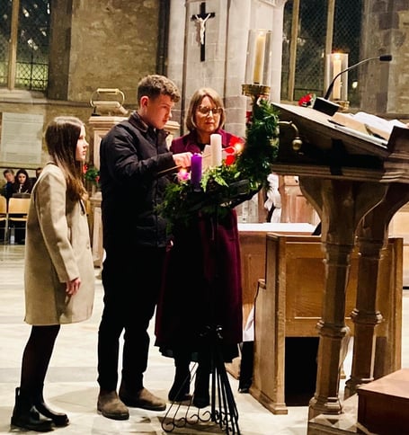 Laura, Owen and Sofia lighting a candle at St David’s Cathedral
