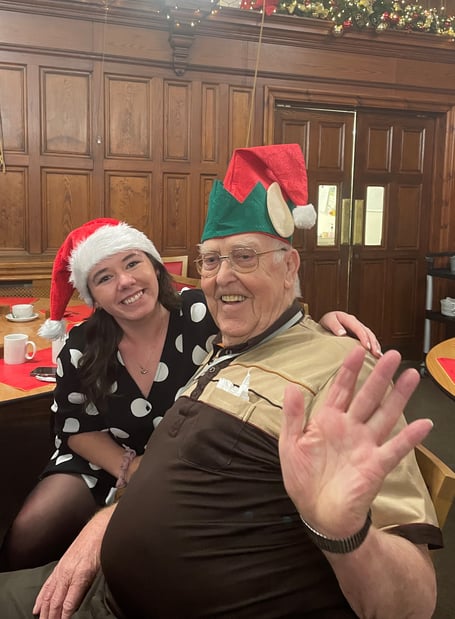 Blind veteran Chris Raine at a Christmas concert with a member of Blind Veterans UK staff