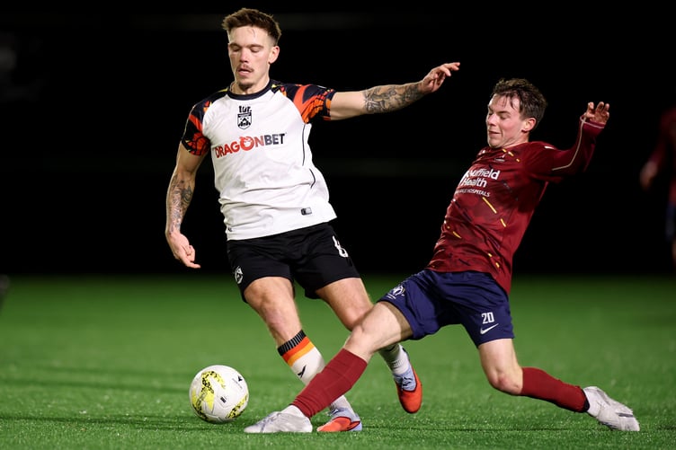 CARDIFF, WALES - 30 DECEMBER 2025: Corey Shephard of Haverfordwest County is fouled by Harri John of Cardiff Met during the JD Cymru Premier 25/26 Phase 1 match between Cardiff Met and Haverfordwest County at Cyncoed Campus in Cardiff on the 30th Decemeber 2025. (Pic by Ashley Crowden/FAW)