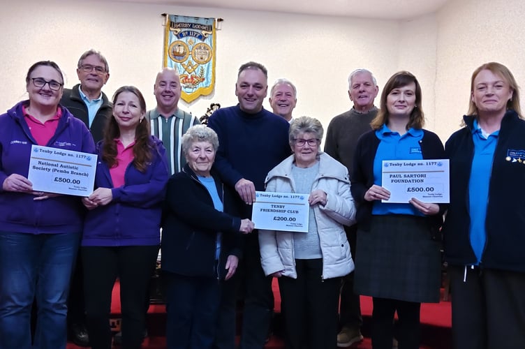 Damian Brown, Master of Tenby Lodge (pictured centre) is seen with fellow lodge members and representatives of the three worthy causes. 