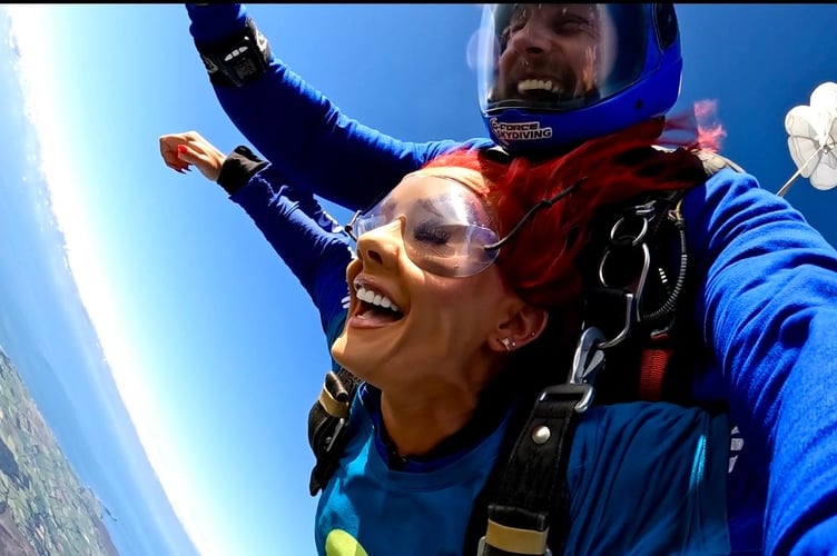 Philippa Langley doing a tandem skydive for Tŷ Hafan Children's Hospice over Swansea Airfield last year (2025)