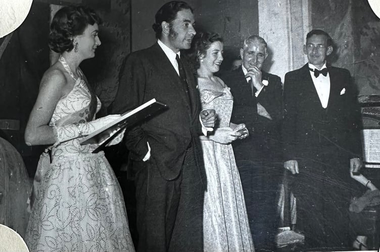 Elizabeth is seen next to Leo Genn wearing her sash after being chosen as Miss Fishguard. 