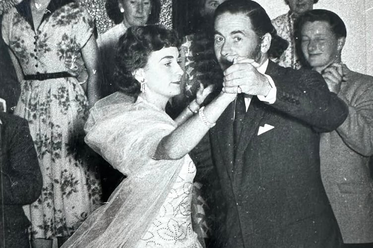 Having been crowned ‘Miss Fishguard 1954’ the 20-year-old Elizabeth Sambrook dances with Hollywood star Leo Genn at Fishguard Town Hall. 