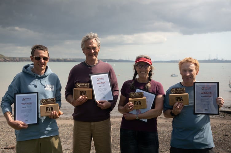  Volunteers (L-R) David Picker, Bob Jones, Leslie Burton and Graham Smith of the Windswept Warriors on the beach with their RYA Cymru Wales Impact Awards © Owen Canton 
