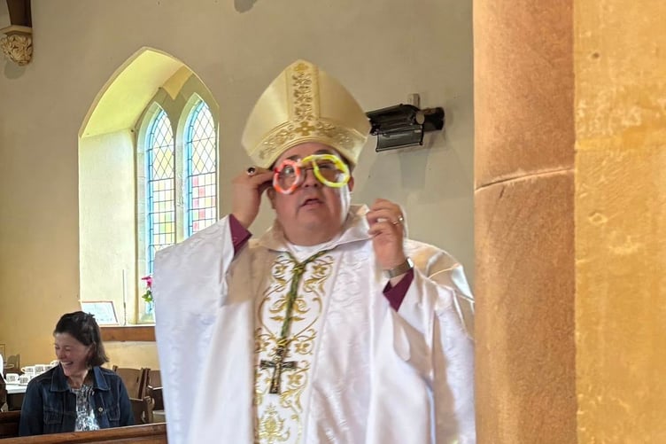 Bishop Dorrien trying on his new spectacles