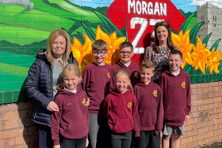 Llandybie Primary School year 3 and year 6 pupils with Deputy Head Teacher, Mrs Emily Williams, and Ashmole & Co Partner in the Ammanford office, Laura Craddock.