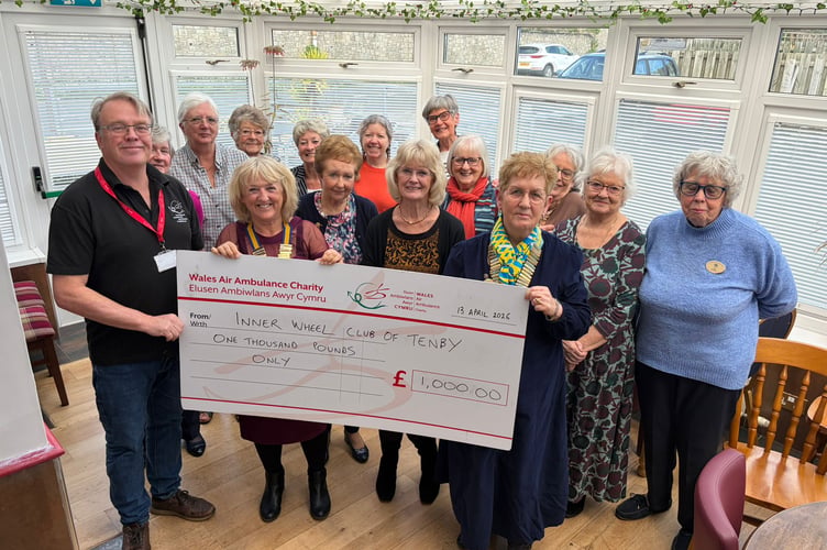 Mike May receives the donation from Tenby Inner Wheel members.