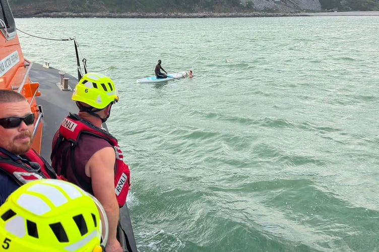 As the lifeboat was preparing to take the casualties and their vessel back to Pendine, the crew spotted a kayaker waving a paddle at them a short distance away and whilst approaching the paddleboarder, they noticed that there was also someone in the water hanging onto the board.