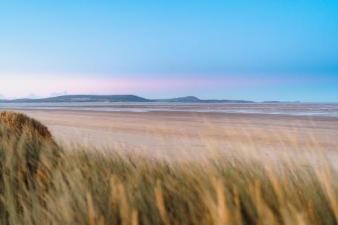 Dyfed-Powys Police is working with the coastguard following reports of two individuals, possibly in distress, near the coastline at Cefn Sidan beach at Pembrey, Burry Port.