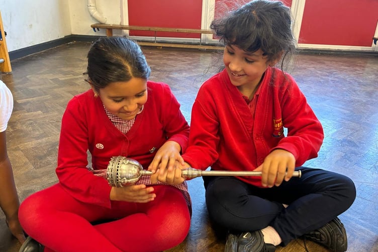 Fenton Primary School pupils examining the historic town mace