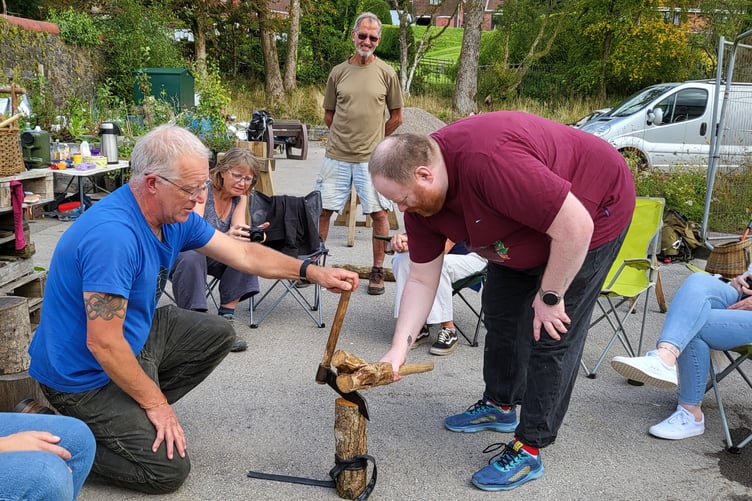 Community members at a wood workshop outside the new community hub.