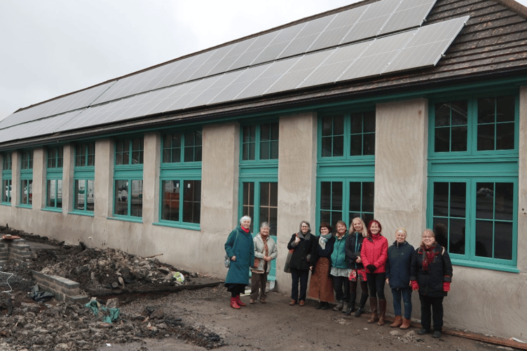 The school being transformed, with a new roof, solar panels, ground source heating, and natural cork insulation.