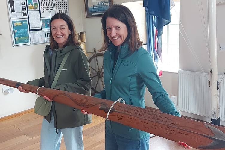 Kasey sisters: Kate (left) and Jane Masey hold a commemorative oar at TS Skirmisher marking the sea cadets’ victory (Image: Supplied).