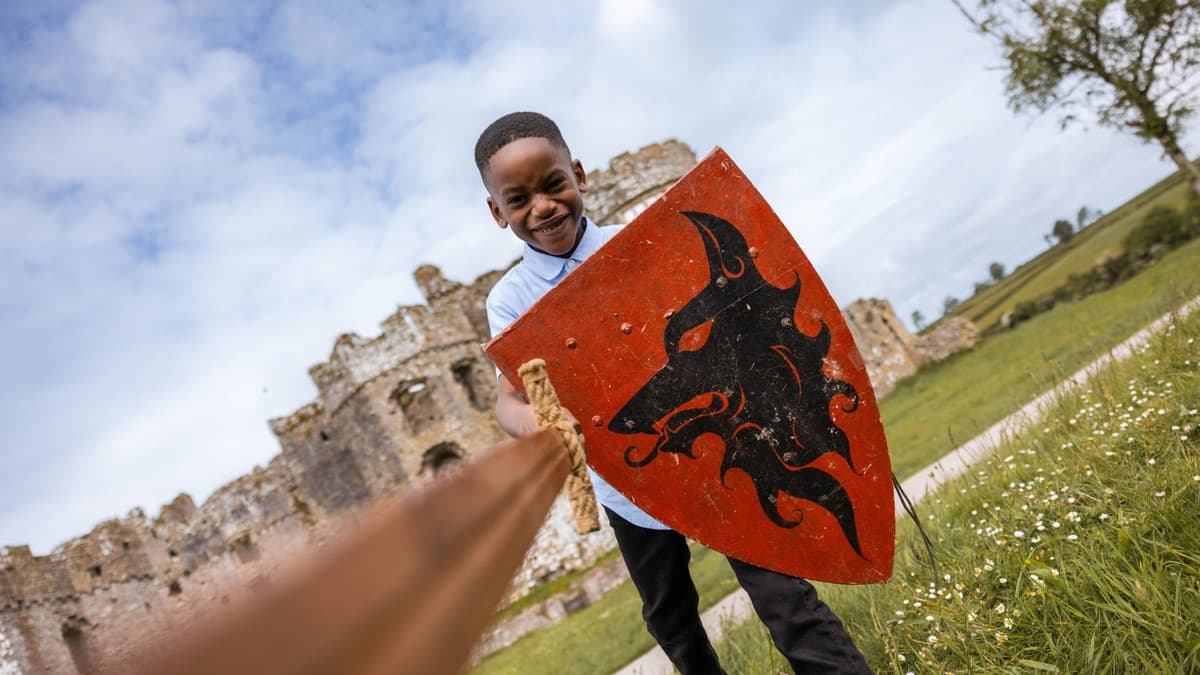 A young visitor taking part in a medieval activity at Carew Castle