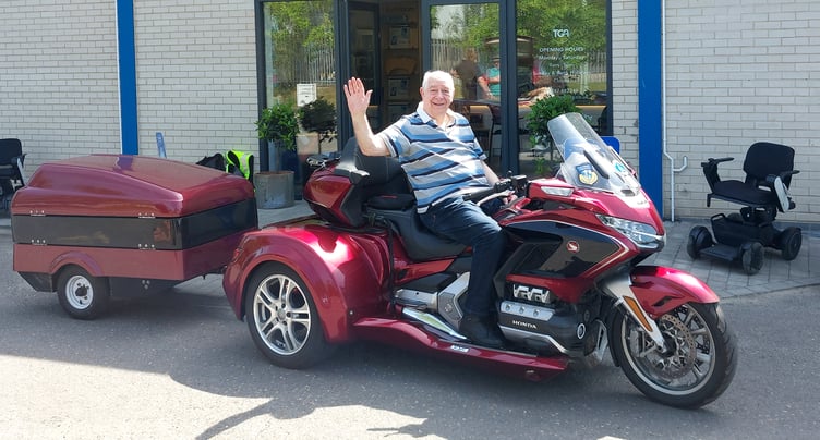 Disabled motorcyclist Max Jones from Pembrokeshire, has discovered complete freedom out of the saddle with a powered wheelchair he tows around the UK and Europe.