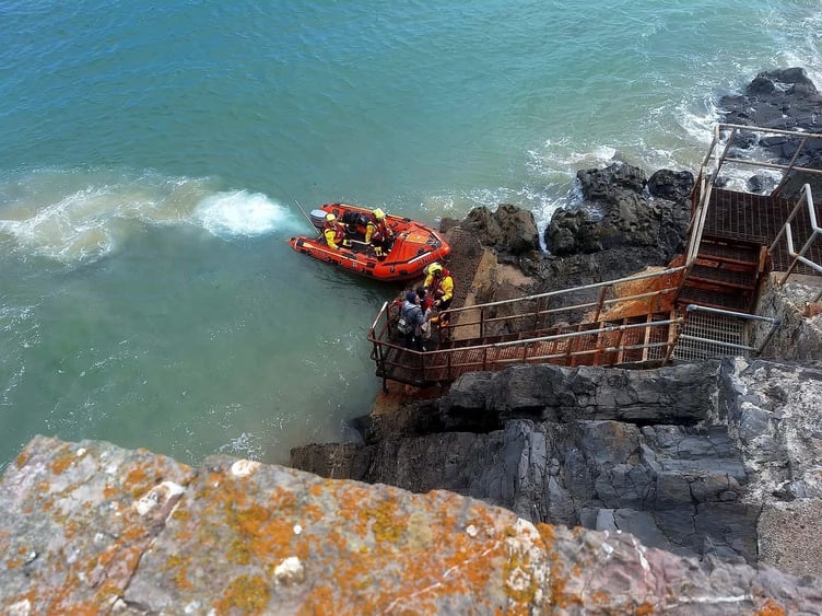 Two people were rescued by Tenby RNLI's inshore lifeboat after being cut off by the tide below the Atlantic Hotel.