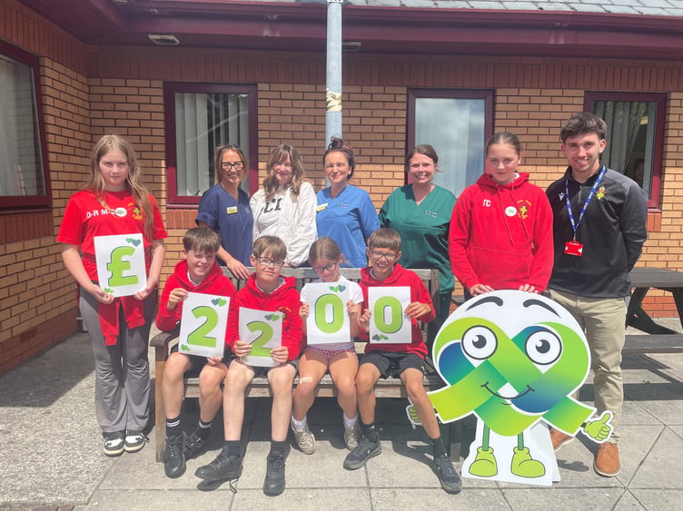 Staff from the Chemotherapy unit with Miss Victoriia, Mr Rhodri Bowen and sports ambassadors from Model Church in Wales School
