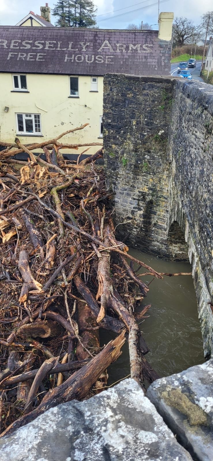 Logs and debris pile up at Pontargothi bridge (pic Claire Gooding and free for use for wire partners)