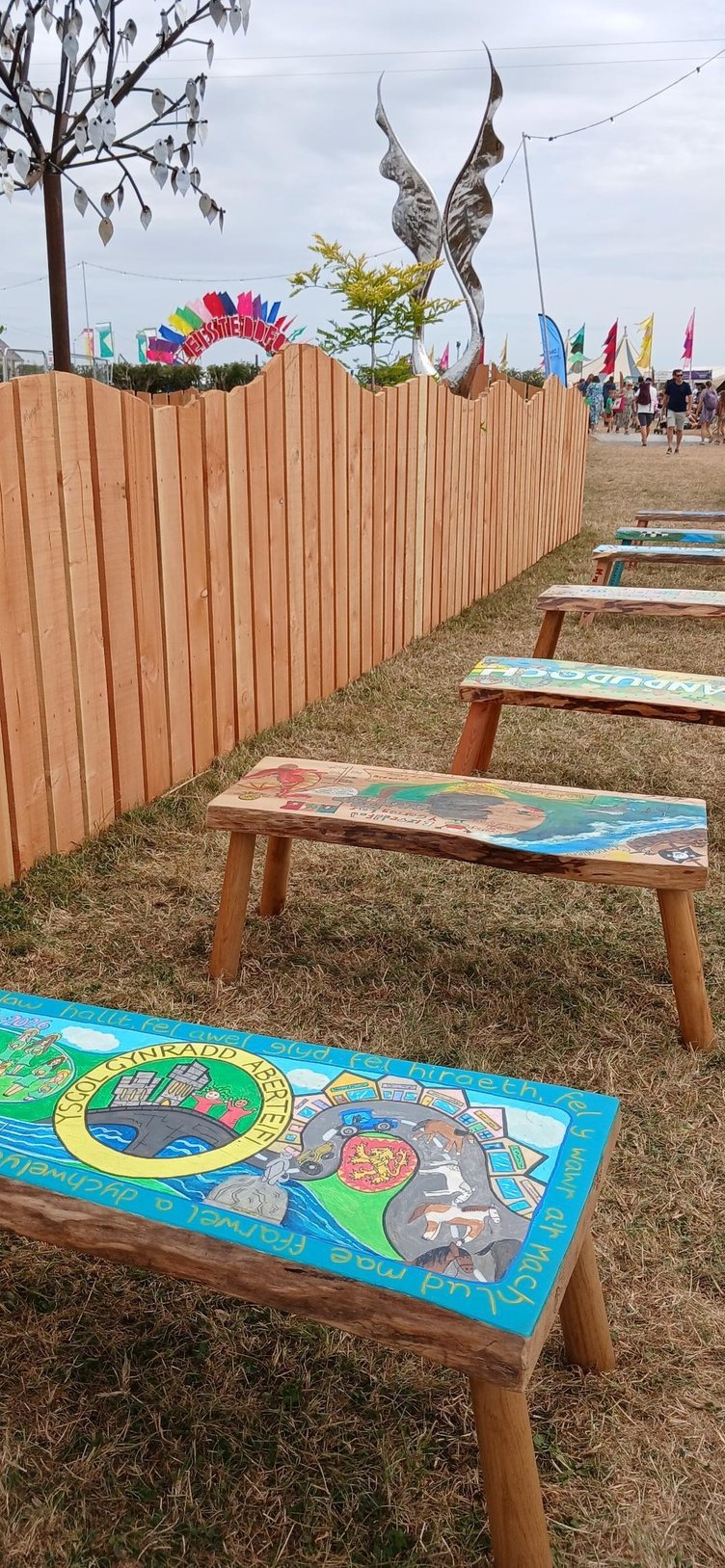Welsh schools join forces in the Stori ar Sedd project, transforming benches into artworks to celebrate local heritage at the Eisteddfod.