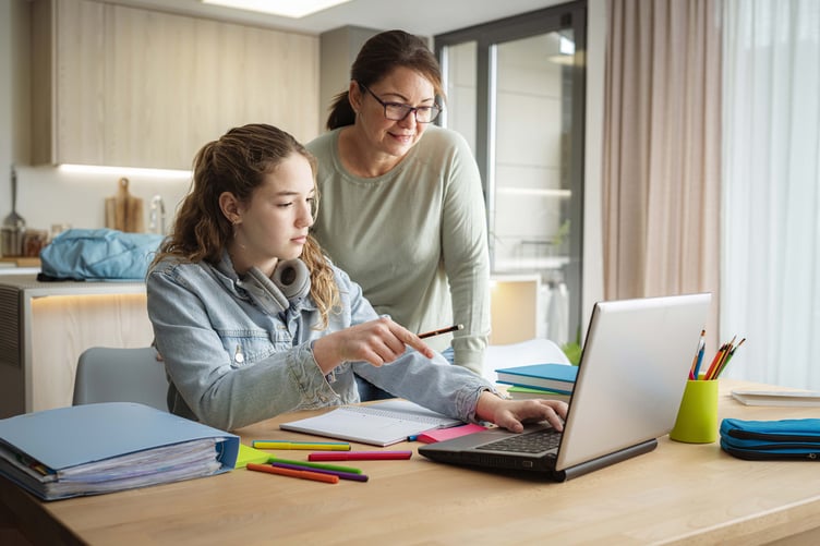 Pupil with parent or carer looking at the laptop