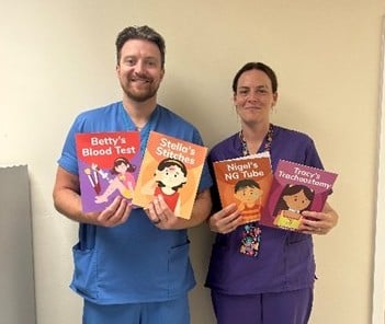 Staff holding the informative books