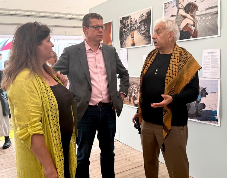 Faisal Saleh, founder of Palestine Museum, discusses genocide with First Minister Rhun ap Iorwerth and Deputy First Minister Sioned Williams. Photo by David Nicholson.