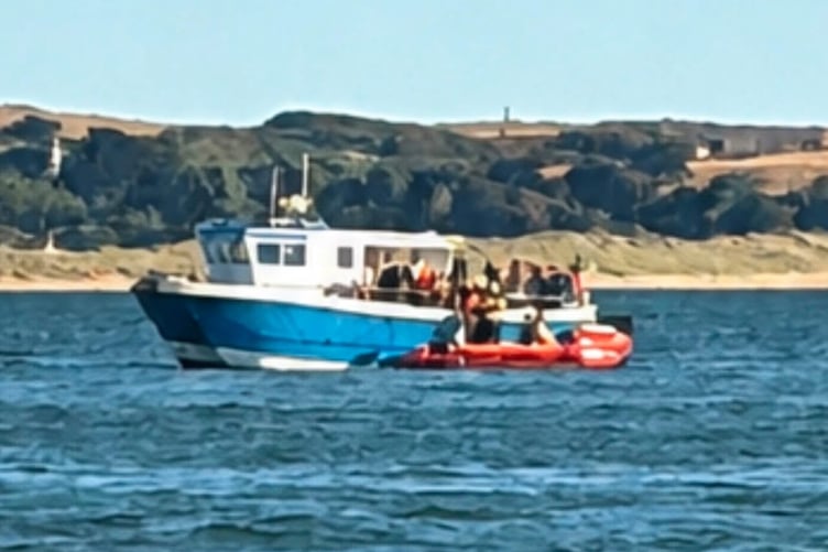 The volunteer crew were quickly on the water and spotted that local Saundersfoot fishing vessel ‘Ebony May’, was in the process of assisting the swimmers.