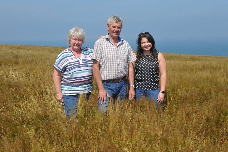 Edna, Andrew and Katie Davies in spring barley