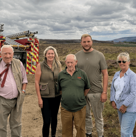 Laura Anne Jones MS pictured with farmers following a spate of wildfires in Wales