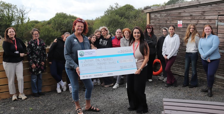 cheque group shot
Helen Heaton and Christina Williams with staff and young people supported by Action for Children