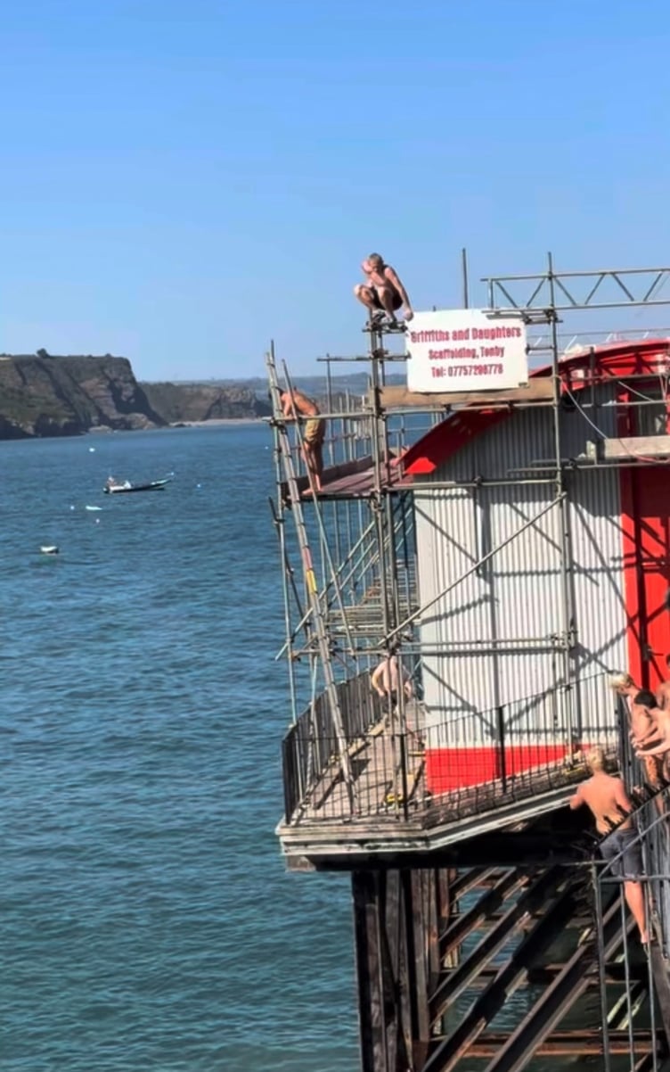 Youngsters jumping off Tenby's old lifeboat station during high tides this summer
