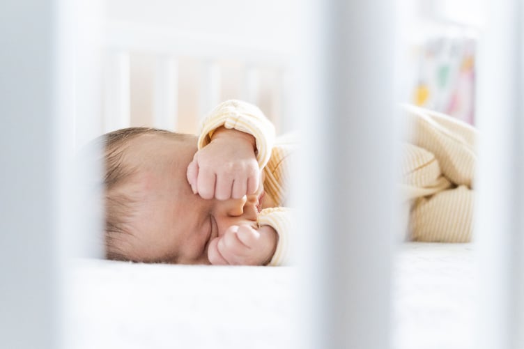 Baby asleep in cot