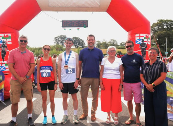 The inaugural Tywi Valley Path Half Marathon in Carmarthenshire saw record-breaking performances and local victories.