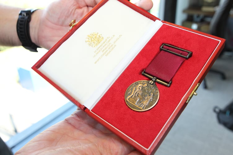 PC Taylor Rees and PC Guto Dafydd have been awarded bronze bravery medals after saving a sleeping woman from a house engulfed with flames.