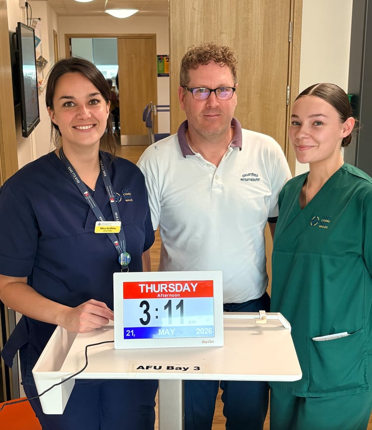Staff from the Acute Frailty Unit with a dementia clock