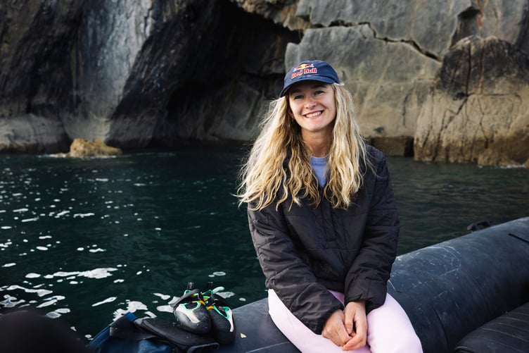 Shauna Coxsey celebrates in a boat after climbing the deep-water solo route Olympiad in Pembrokeshire, Wales on August 22, 2026. // Jessica Glassberg / Red Bull Content Pool // SI202609090010 // Usage for editorial use only //