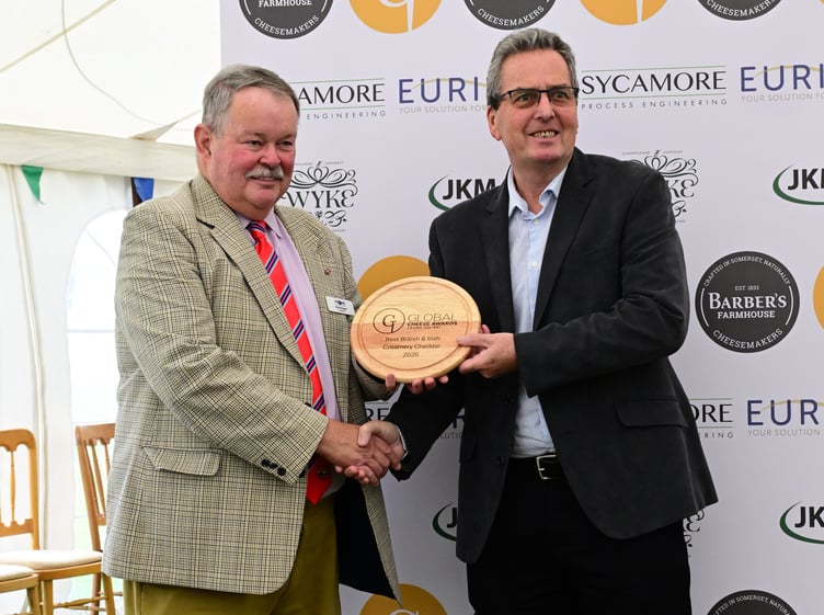 First Milk’s Customer Quality Manager Jack Eade receiving the Best British & Irish Creamery Cheddar award from Frome & District Agricultural Society President Paul Hooper.